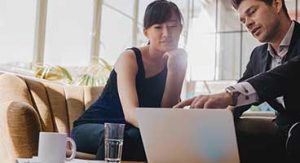 Two people looking at laptop together